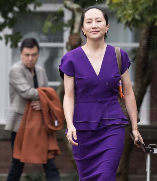 Huawei chief financial officer Meng Wanzhou, centre, who is out on bail and remains under partial house arrest after she was detained last year at the behest of American authorities, and her husband Liu Xiaozong, right, leave their home to attend a court hearing in Vancouver, on Monday, September 23, 2019. THE CANADIAN PRESS/Darryl Dyck