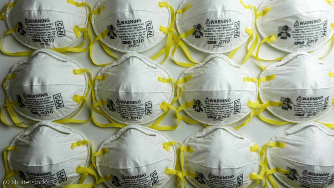 Rows of white masks with yellow straps (© Shutterstock)