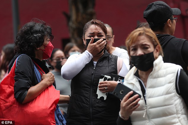 A woman cries after the seismic alert was activated in Mexico City, Mexico