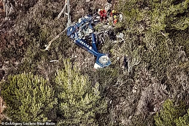 Mystery surrounds his death, as the crash happened in good weather - and after another passenger reportedly cancelled last minute. Pictured: Rescue workers at the scene of the helicopter crash